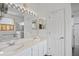 Bright bathroom with double sinks, a large mirror, and a glass-enclosed shower at 468 Alinole Loop, Lake Mary, FL 32746