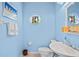 Small bathroom with blue walls, unique circular window, and coordinated decor at 468 Alinole Loop, Lake Mary, FL 32746