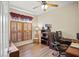 Office/bedroom with built-in desk, shutters on window, wood flooring and a ceiling fan at 468 Alinole Loop, Lake Mary, FL 32746