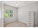 Neutral bedroom with ceiling fan and a bright window allowing for natural light at 468 Alinole Loop, Lake Mary, FL 32746
