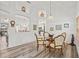 Formal dining area with wood-look flooring, a chandelier, and neutral tones creates a cozy and inviting atmosphere at 468 Alinole Loop, Lake Mary, FL 32746