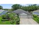 Charming single-story home boasts a well-manicured lawn, mature landscaping, and a three-car garage for ample parking at 468 Alinole Loop, Lake Mary, FL 32746