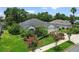 Well-maintained home featuring a lush lawn, colorful landscaping, and a three-car garage for added convenience at 468 Alinole Loop, Lake Mary, FL 32746