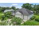 This home features an attached three-car garage, a well-maintained lawn, and lush landscaping around the property at 468 Alinole Loop, Lake Mary, FL 32746