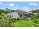 Home exterior with stucco and lush landscaping around a screened in back patio at 468 Alinole Loop, Lake Mary, FL 32746