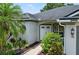 Inviting front entrance with double doors, lush landscaping, and a well-manicured lawn creating a welcoming approach at 468 Alinole Loop, Lake Mary, FL 32746