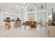Open-concept living area with tile flooring, seamlessly connecting to the kitchen and dining area at 468 Alinole Loop, Lake Mary, FL 32746