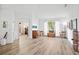 Spacious living room with wood-look flooring, high ceilings, and large windows offering plenty of natural light at 468 Alinole Loop, Lake Mary, FL 32746
