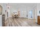 Bright living room with wood-look flooring, high ceilings, and an elegant chandelier creating a spacious feel at 468 Alinole Loop, Lake Mary, FL 32746
