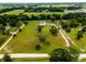 Aerial view of the home set within the lush, green landscape at 485 Nw 71St Ave, Ocala, FL 34482