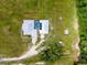 Aerial view of the home, showcasing its metal roof, enclosed pool and the expansive property at 485 Nw 71St Ave, Ocala, FL 34482