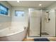Bathroom with a soaking tub and separate glass-enclosed shower at 485 Nw 71St Ave, Ocala, FL 34482