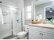Bright bathroom features a glass-enclosed shower, modern vanity, and white tiling in a well-lit space at 485 Nw 71St Ave, Ocala, FL 34482