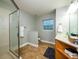 Bathroom with a glass shower, single vanity, and a window for natural light at 485 Nw 71St Ave, Ocala, FL 34482