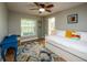Bright bedroom with a daybed, blue desk and chair, and colorful area rug at 485 Nw 71St Ave, Ocala, FL 34482
