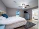 Cozy primary bedroom with a ceiling fan, light-filled window, and ensuite bathroom with an updated vanity at 485 Nw 71St Ave, Ocala, FL 34482