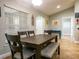 The dining room has a wooden table, chairs, bench, window and tiled floors at 485 Nw 71St Ave, Ocala, FL 34482