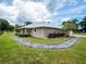 Charming home exterior with a stone walkway leading to the entrance, complemented by manicured landscaping at 485 Nw 71St Ave, Ocala, FL 34482