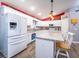 Bright kitchen features white cabinetry, stainless steel appliances, granite countertops, and a breakfast bar with seating at 485 Nw 71St Ave, Ocala, FL 34482