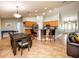 Open-concept kitchen features wood cabinetry, a breakfast bar with seating, and adjacent dining area at 485 Nw 71St Ave, Ocala, FL 34482