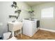 Bright laundry room with a sink, storage shelves, and a washer and dryer at 485 Nw 71St Ave, Ocala, FL 34482