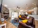 Open-concept living room with a stone fireplace, comfortable seating, and a view of the adjacent kitchen at 485 Nw 71St Ave, Ocala, FL 34482