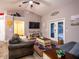 Comfortable living room with a vaulted ceiling, a cozy sitting area, and glass doors leading to the outdoor space at 485 Nw 71St Ave, Ocala, FL 34482