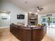 Cozy living room with a stone fireplace, plush seating, and seamless access to the pool area at 485 Nw 71St Ave, Ocala, FL 34482