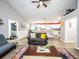 Open-concept living room flowing into a kitchen with granite counters, island seating, and wood-look flooring at 485 Nw 71St Ave, Ocala, FL 34482
