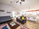 Inviting living room boasts vaulted ceiling, modern furniture, and a seamless flow into the adjacent dining and kitchen areas at 485 Nw 71St Ave, Ocala, FL 34482