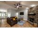 Inviting living room with a stone fireplace, comfortable seating, and an open layout at 485 Nw 71St Ave, Ocala, FL 34482