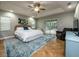 Spacious main bedroom with a ceiling fan, en suite bathroom, and sliding door access to the lanai at 485 Nw 71St Ave, Ocala, FL 34482