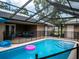Sparkling pool with a safety fence enclosed by dome, offering a refreshing escape at 485 Nw 71St Ave, Ocala, FL 34482
