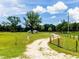 Rural property entrance, lush pastures and distant residence at 485 Nw 71St Ave, Ocala, FL 34482