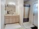 Bathroom featuring single sink vanity with linen cabinet and shower with curtain at 517 Westwind Dr, Davenport, FL 33896