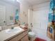 Bathroom with single vanity, shower/tub combo, and beach-themed decor accents at 517 Westwind Dr, Davenport, FL 33896