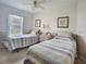 Bedroom with two twin beds, neutral tones, and natural light creates a comfortable space at 517 Westwind Dr, Davenport, FL 33896