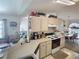 Functional kitchen with plenty of counter space, neutral cabinetry, and adjacent breakfast nook at 517 Westwind Dr, Davenport, FL 33896