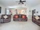 Large living room featuring comfortable leather seating, an open layout, and easy access to the kitchen at 517 Westwind Dr, Davenport, FL 33896
