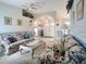 Open-concept living area featuring comfortable seating, stylish floral accents, and bright natural light at 517 Westwind Dr, Davenport, FL 33896