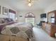 Relaxing main bedroom with light carpet, natural light, ceiling fan, and soft decor at 517 Westwind Dr, Davenport, FL 33896