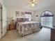 Cozy bedroom with carpet, ceiling fan, and neutral tones exudes relaxation and comfort at 517 Westwind Dr, Davenport, FL 33896