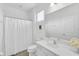 Minimalist bathroom featuring a white vanity, toilet, shower with curtain, and a large mirror at 518 Marcello Blvd, Kissimmee, FL 34746
