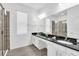 Bright bathroom featuring double sinks, granite countertops, and modern fixtures throughout at 518 Marcello Blvd, Kissimmee, FL 34746