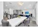 Open floor plan featuring a kitchen island, stairs, a dining table, and a living room at 518 Marcello Blvd, Kissimmee, FL 34746