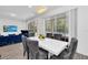 Open floor plan with a dining area with sliding glass doors to the pool, chairs, and blue couch at 518 Marcello Blvd, Kissimmee, FL 34746