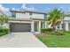 Two-story home with a two-car garage, tidy landscaping, and well-maintained lawn at 518 Marcello Blvd, Kissimmee, FL 34746