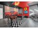 Stylish game room boasts a foosball table, pool table, and a vibrant mural of a red sports car at 518 Marcello Blvd, Kissimmee, FL 34746