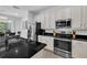 Modern kitchen with stainless steel appliances, granite countertops, and white cabinetry at 518 Marcello Blvd, Kissimmee, FL 34746