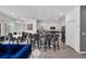 Open-concept kitchen with a large island, barstool seating, and stainless steel appliances at 518 Marcello Blvd, Kissimmee, FL 34746